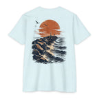 Ice blue Port Aransas Jetty Sunset fishing shirt featuring crashing Gulf waves, granite jetties, seabirds, and a coastal sunset