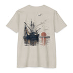 Sand vintage shrimp boat sunset fishing shirt featuring a Gulf Coast shrimp trawler on calm coastal waters at sunset